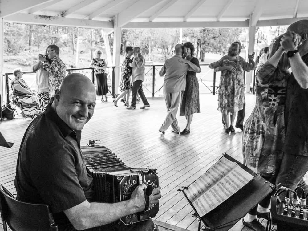 Dancers at an Argentine tango milonga in Colchester, with a bandoneon player in the foreground